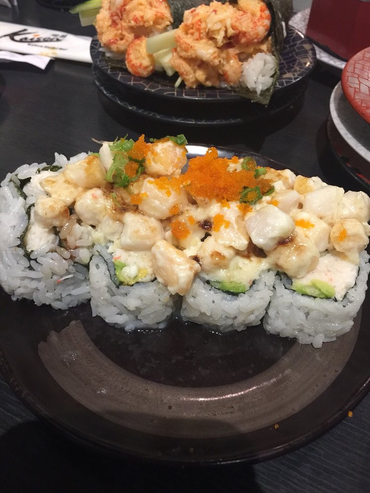 Sushi roll topped with baked scallops