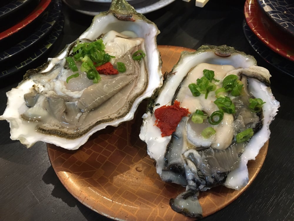 Two raw oysters with ponzu and green onion