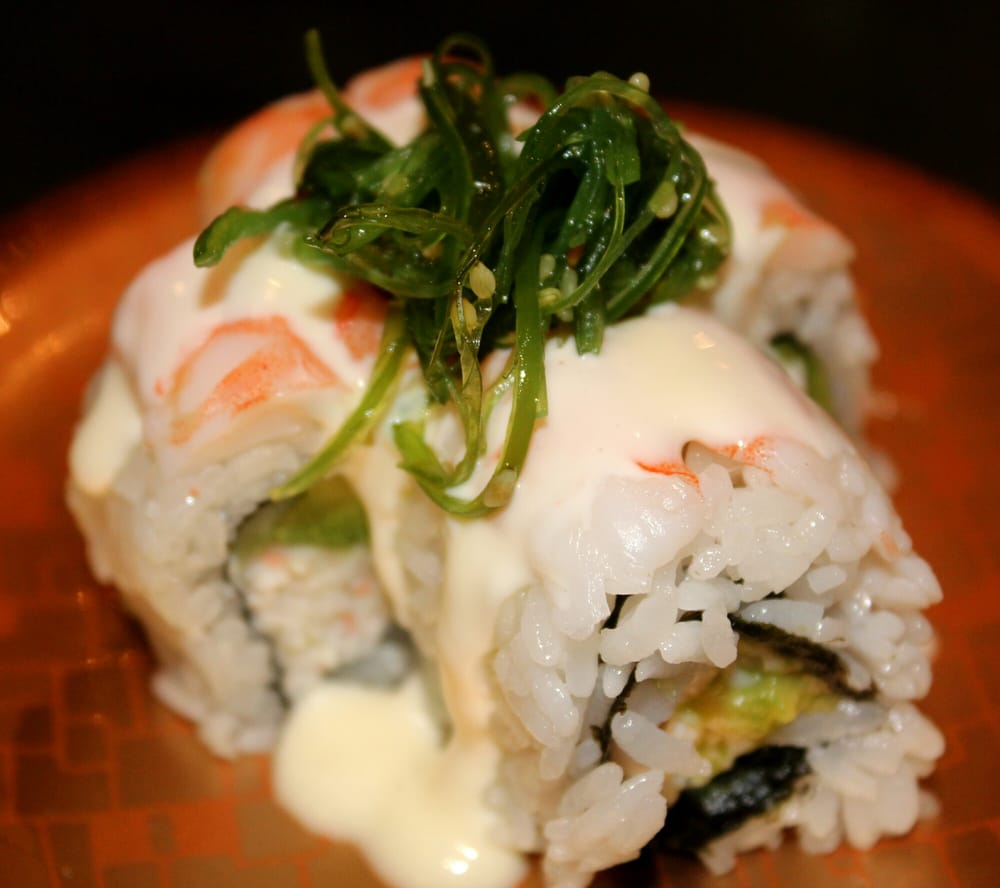 Shrimp roll topped with seaweed salad